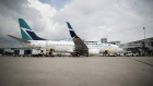 A Boeing Co. 737-800 WestJet Airlines plane sits at a gate at Toronto Pearson International Airport. Photographer: Brent Lewin/Bloomberg
