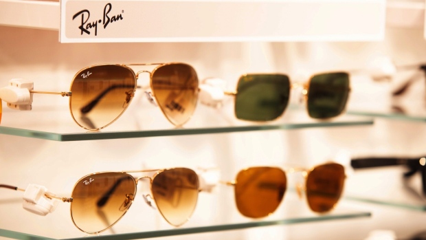 A range of Ray-Ban sunglasses, manufactured by EssilorLuxottica SA, sit on display inside a Pearle opticians store, operated by GrandVision NV, in Amsterdam, Netherlands, on Wednesday, July 1, 2020. EssilorLuxottica, the maker of Ray-Ban sunglasses, remains committed to its proposed 7.3 billion-euro ($8.3 billion) purchase of retailer GrandVision NV, people with knowledge of the matter said. Photographer: Peter Boer/Bloomberg