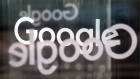 The Google Inc. company logo sits on revolving doors at the company's new U.K. headquarters at Six St Pancras Square in London, U.K.