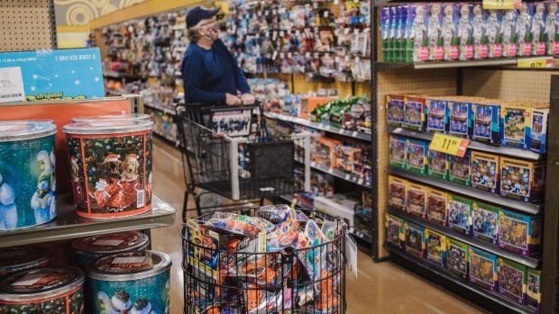 A worker restocks toys at Kroger Marketplace in Versailles, Kentucky, U.S., on Tuesday, Nov. 24, 2020. The National Retail Federation on Monday forecast that holiday sales during November and December will increase between 3.6 percent and 5.2 percent over 2019 to a total between $755.3 billion and $766.7 billion.