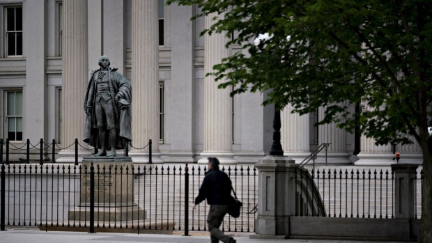 A pedestrian walks near the U.S. Treasury building in Washington, D.C., U.S., on Wednesday, May 20, 2020. Treasury Secretary Steven Mnuchin said he plans to use all of the $500 billion that Congress provided to help the economy through direct lending from his agency and by backstopping Federal Reserve lending programs. Photographer: Andrew Harrer/Bloomberg