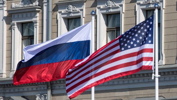 A Russian national flag, left, an American national flag, center, and a Finnish national flag fly outside the Presidential Palace in Helsinki, Finland, on Monday, July 16, 2018. U.S. President Donald Trump prepared to meet Russian President Vladimir Putin in Helsinki on Monday, under pressure to confront his Russian counterpart over Kremlin meddling in the 2016 election and with concerns rising that the U.S. is abandoning the current international order. Photographer: Chris Ratcliffe/Bloomberg Economics