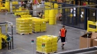 An employee pulls a pallet jack carrying plastic crates containing online orders at the Amazon.com Inc. fulfillment center in Robbinsville, New Jersey, U.S., on Thursday, June 7, 2018. Seattle-based Amazon hasn't yet announced the exact date for this year's Amazon Prime Day, the e-commerce giant’s big July sales promotion. Photographer: Bess Adler/Bloomberg