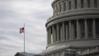 An American flag flies at the U.S. Capitol Building in Washington, D.C., U.S, on Sunday, Dec. 20, 2020. Congressional negotiators cleared the last significant obstacle for pandemic relief legislation with a compromise in a dispute over the future of Federal Reserve emergency lending programs, setting up a possible vote on Sunday.