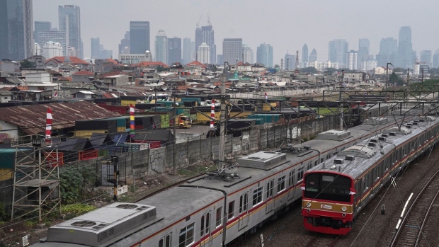Trains travel along railway tracks near Tanah Abang station in Jakarta, Indonesia, on Tuesday, Aug. 4, 2020. Indonesia is scheduled to announce its second-quarter gross domestic product (GDP) figures on Aug. 5. Photographer: Dimas Ardian/Bloomberg