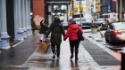 Pedestrians holding hands walk with a Bloomingdale's Inc. shopping bag while in the SoHo neighborhood of New York, U.S., on Monday, Dec. 14, 2020. The U.S. Census Bureau is scheduled to release retail sales figures on December 16. Photographer: Gabby Jones/Bloomberg