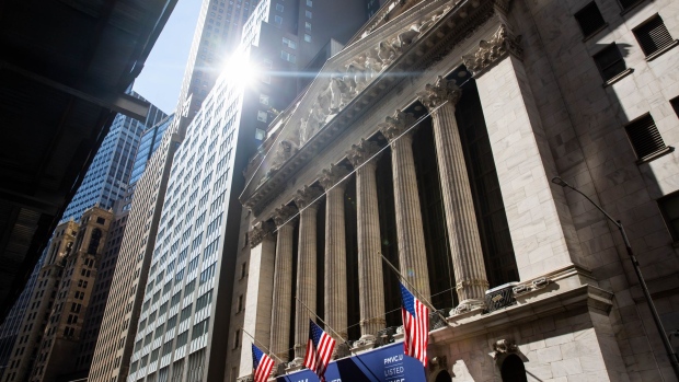U.S. flags fly in front of the New York Stock Exchange. Photographer: Michael Nagle/Bloomberg