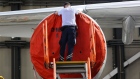 A worker secures a protective cover to a CFM International Inc. CFM56 turbofan engine on a grounded Airbus SE A340 passenger aircraft, operated by Deutsche Lufthansa AG, in a Lufthansa Technik AG hangar in Frankfurt, Germany, on Thursday, July 30, 2020. Airlines the world over have drastically cut back on flights due to border restrictions and a lack of appetite for travel, particularly internationally. Photographer: Alex Kraus/Bloomberg