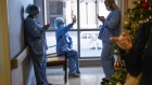 Healthcare workers wait to receive the Pfizer-BioNTech Covid-19 vaccine at Regional Medical Center in San Jose, California, U.S., on Friday, Dec. 18, 2020. Vaccinations in the U.S. began this week with health-care workers, and 24 states reported the first 49,567 doses administered.