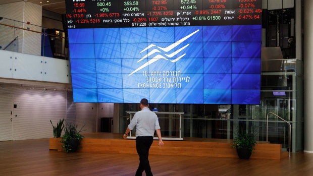 A visitor passes a stock price indicator board in the lobby of the Tel Aviv Stock Exchange Ltd. (TASE) in Tel Aviv, Israel, on Monday, Sept. 2, 2019. Embattled Israeli Prime Minister Benjamin Netanyahu, running in an election that could be the fight of his political life, said he hopes to annex all Jewish West Bank settlements. Photographer: Kobi Wolf/Bloomberg
