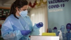 A nurse handles a vial of the Pfizer-BioNTech Covid-19 vaccine at the Feixa Llarga nursing home, in Barcelona, Spain, on Sunday, Dec. 27, 2020. An unprecedented continent-wide vaccination campaign was underway in Europe, with Italy, Germany, Austria, France and the Nordics all launching their inoculation programs, less than a week after the EU cleared a shot developed by Pfizer Inc. and BioNTech SE.