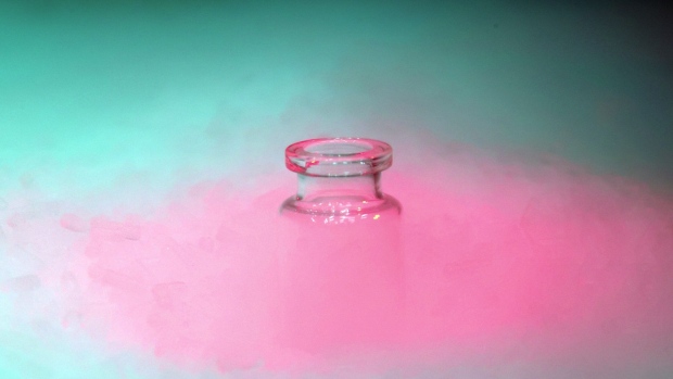 A glass medical vaccine vial in dry ice vapor in an arranged photograph in Wurzburg, Germany, on Wednesday, Nov. 18, 2020. Freezers required to store Covid-19 vaccines are in place at health systems that are preparing to administer the initial doses once the two leading candidates for shots receive a green light from regulators, U.S. health officials said Wednesday. Photographer: Alex Kraus/Bloomberg