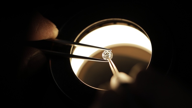 A employee inspects a diamond. Photographer: Kiyoshi Ota/Bloomberg