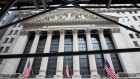 American flags are displayed outside the New York Stock Exchange (NYSE) in New York, U.S., on Monday, July 20, 2020. U.S. stocks fluctuated in light trading as investors are keeping an eye on Washington, where lawmakers will begin hammering out a rescue package to replace some of the expiring benefits earlier versions contained.