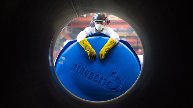 A worker a Gazprom PJSC end cap to a steel pipe in Chelyabinsk, Russia. Photographer: Andrey Rudakov/Bloomberg