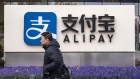 A pedestrian walks past an Alipay sign outside an Ant Group Co. office building in Shanghai, China. Photographer: Qilai Shen/Bloomberg