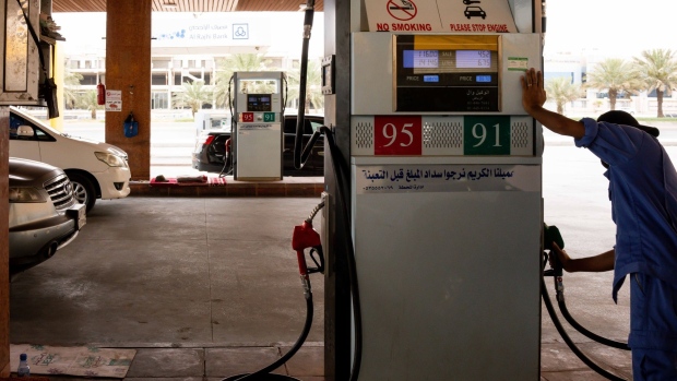 An attendant returns the pump handle after refilling an automobile with fuel at a gas station in Riyadh, Saudi Arabia, on Tuesday, May 19, 2020. Hit simultaneously by plunging crude prices and coronavirus shutdowns, the non-oil economy is expected to contract for the first time in over 30 years. Photographer: Tasneem Alsultan/Bloomberg