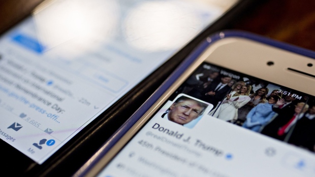 The Twitter Inc. account of U.S. President Donald Trump, @realDoanldTrump, is seen on an Apple Inc. iPhone arranged for a photograph in Washington, D.C., U.S., on Friday, Jan. 27, 2017. Mexican President Enrique Pena Nieto canceled a visit to the White House planned for next week after Trump on Thursday reinforced his demand, via Twitter, that Mexico pay for a barrier along the U.S. southern border to stem illegal immigration.