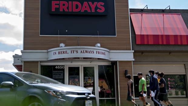 People arrive at a TGI Friday's restaurant.