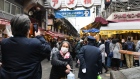 People wearing protective face masks wait in line to offer prayers on the first business day of the year at the Kanda Myojin shrine in Tokyo, Japan, on Monday, Jan. 4, 2021. Japanese stocks declined on the first trading day of the year following reports of a state of emergency, with the benchmark Topix Index falling as much as 1.6%. Photographer: Soichiro Koriyama/Bloomberg