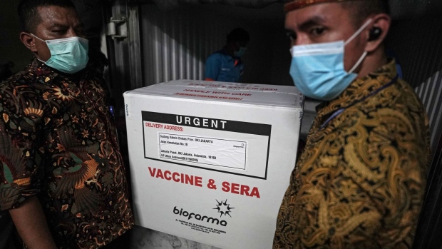 Workers unload boxes of the Sinovac Biotech Ltd. coronavirus vaccine at the DKI Jakarta Provincial Health Office in Jakarta, Indonesia, on Thursday, Jan. 7, 2021. President Joko Widodo is set to get vaccinated against the coronavirus on Jan. 13, which would kick off Indonesia’s inoculation program.