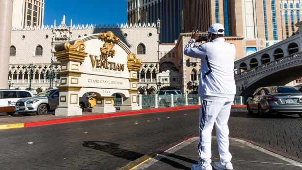 A person uses a mobile device to take a photograph of the Venetian Resort in Las Vegas, Nevada, U.S., on Sunday, Oct. 18, 2020. Las Vegas Sands Corp. is scheduled to release earnings figures on October 21.