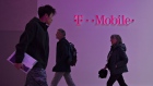 FILE: Shoppers walk through the lobby of a T-Mobile US Inc. store in Chicago, Illinois, U.S., on Friday, Oct. 21, 2016. T-Mobile US Inc. agreed to acquire Sprint Corp. for $26.5 billion in stock, a wager that the carriers can team up to build a next-generation wireless network and get a jump on industry leaders Verizon Communications Inc. and AT&T Inc. Our editors select the best archive images from the two companies. Photographer: Bloomberg/Bloomberg