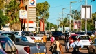 Pedestrians walk past parked vehicles outside a Total SA gas station in Maputo, Mozambique, on Thursday, March 23, 2017. Mozambique missed a $119 million payment due Tuesday on a loan Credit Suisse Group AG arranged, the second debt repayment the government failed to make in as many months. Photographer: Waldo Swiegers/Bloomberg
