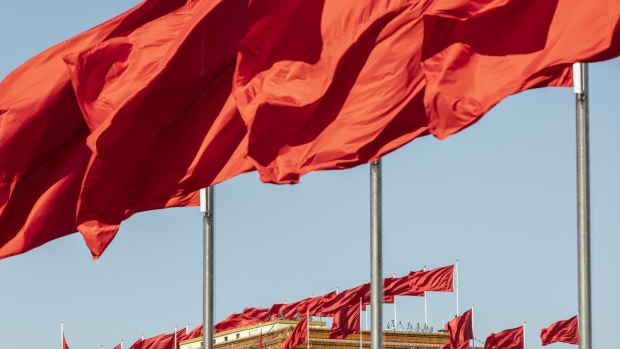 Chinese national flags fly atop the Great Hall of the People in Beijing, China, on Tuesday, Sept. 24, 2019. Streets have been cleaned and security increased before the Oct. 1 holiday, when Chinese President Xi Jinping will preside over a military parade and deliver a speech celebrating the strength of China and the party.