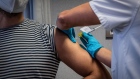 A medical worker administers an injection to a volunteer during a phase 3 trial of the Johnson & Johnson Covid-19 vaccine by the Germans Trias i Pujol hospital and Foundation for the Fight against AIDS and Infectious Diseases, in the Badalona district of Barcelona, Spain, on Thursday, Dec. 17, 2020. Johnson & Johnson is in the midst of stage three trials, including one in South Africa, for its vaccine.
