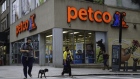Pedestrians cross a street in front of a Petco Animal Supplies Inc. store in New York, U.S., on Wednesday, Sept. 9, 2020. The owners of Petco Animal Supplies Inc. are exploring a sale or initial public offering that could value the retail chain at $6 billion, including debt, according to people with knowledge of the matter.
