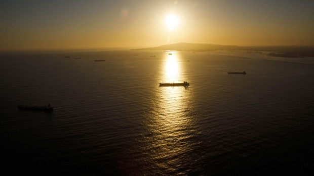 Oil tankers are seen anchored in the Pacific Ocean as the sun sets in this aerial photograph taken above Long Beach, California, U.S., on Friday, May 1, 2020. The volume of oil on vessels located just offshore the state peaked at 26 million barrels over the weekend, about a quarter of the world's daily consumption, before dropping to 22 million barrels on Monday, according to Paris-based Kpler SAS, which tracks tanker traffic. Photographer: Patrick T. Fallon/Bloomberg