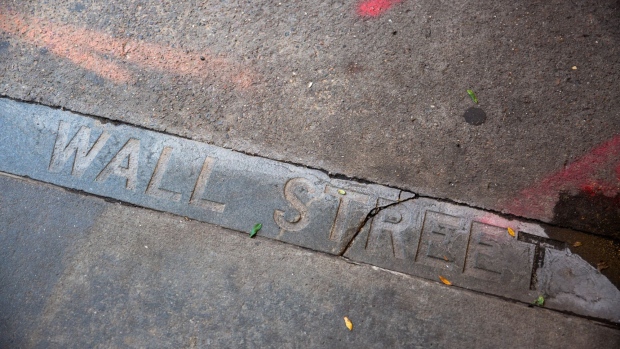 "Wall Street" etched on the curb near the New York Stock Exchange (NYSE) in New York, U.S., on Wednesday, Sept. 30, 2020. Shares of Palantir Technologies, a data mining company co-founded by technology billionaire Peter Thiel, opened trading today on the New York Stock Exchange at $10 after the company sold shares to investors in a direct offering. Photographer: Michael Nagle/Bloomberg
