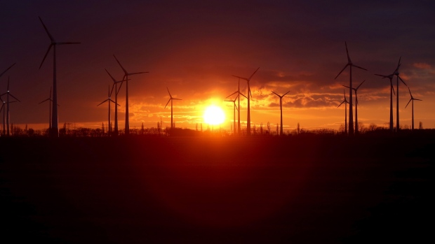 Wind turbines at a wind farm during sunset in Nauen Brandenburg, Germany, on Wednesday, Dec. 30, 2020. It was a pivotal year in the transition toward renewable energy, underpinned by massive government spending pledges and corporations working to burnish their environmental, social and governance credentials. Photographer: Liesa Johannssen-Koppitz/Bloomberg