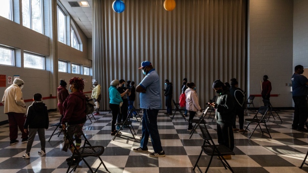 Voters stand in line to cast ballots at a polling location during the Senate runoff elections in Atlanta.. Photographer: Dustin Chambers/Bloomberg