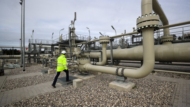 A worker inspects pipework at the Nord Stream 2 gas pipeline landing facility on the Baltic Sea coastline in Lubmin, Germany, on Wednesday, Nov. 5, 2020. Chancellor Angela Merkel’s district on the Baltic coast was the site of the last major Soviet military project in communist East Germany and is now at the center of a deepening rift between Cold War allies. Photographer: Alex Kraus/Bloomberg