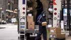 Drivers for an independent contractor to FedEx Corp. wearing protective masks unload a Ground truck in Chicago, Illinois, U.S., on Monday, Nov. 30, 2020. Online shoppers in the U.S. are expected to drop a record-busting $12.7 billion on Cyber Monday -- the busiest e-commerce day of the year -- presenting a valuable opportunity for retailers whose websites, customer service departments and delivery operations can withstand the period of crushing traffic. Photographer: Christopher Dilts/Bloomberg
