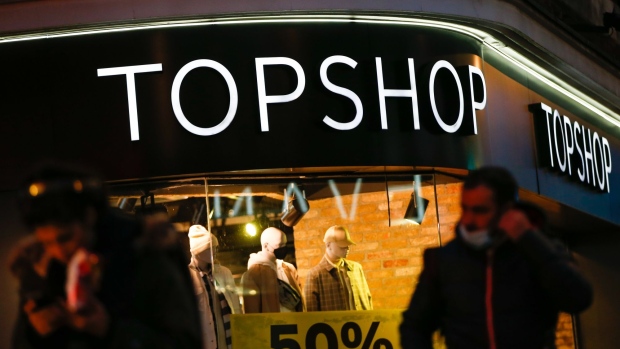 Pedestrians pass a Topshop store in London, U.K., on Wednesday, Dec. 2, 2020. Most of England's retailers are emerging from lockdown, with just over three weeks left until Christmas and the outlook for the industry looking far worse than before they closed their doors a month ago.