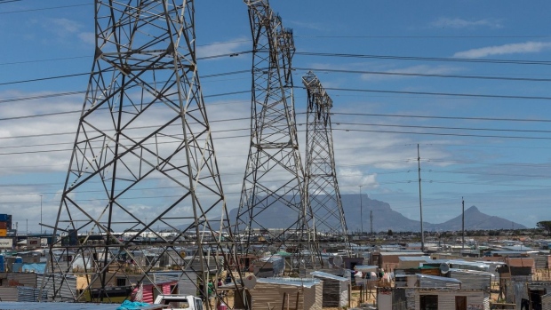 Electricity transmission pylons between informal housing in the Dunoon township in Cape Town, South Africa, on Wednesday, Nov. 25, 2020. The decision to begin installing new steam generators at the Koeberg plant near Cape Town underscores state-owned Eskom's confidence that it will win approval to prolong production of low-emissions nuclear power into the middle of the century. Photographer: Dwayne Senior/Bloomberg