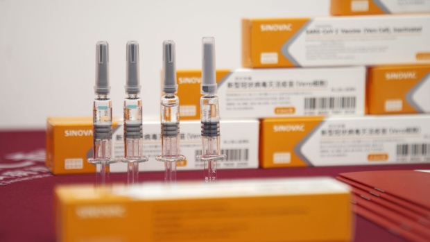 Vials of Sinovac Biotech Ltd.'s CoronaVac SARS-CoV-2 vaccine are displayed at a media event in Beijing, China, on Thursday, Sept. 24, 2020. Chinese vaccine developer Sinovac said that countries running its final-stage clinical trials like Brazil, Indonesia and Turkey will get its coronavirus shots at the same time as China, underscoring how vaccine supply agreements could cement diplomatic ties in the Covid-19 era. Photographer: Nicolas Bock/Bloomberg