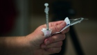 A healthcare worker unwraps a syringe while administering doses of the Pfizer-BioNTech Covid-19 vaccine in a care home in Paris, France, on Thursday, Jan. 7, 2021. A majority of French people intend to be vaccinated against Covid-19, crossing the 50% level for the first time, an Ifop-Fiducial poll showed. Photographer: Nathan Laine/Bloomberg