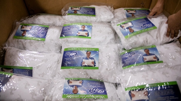 A worker packs pillows in a box at the My Pillow Inc. production facility in Shakopee, Minnesota.
