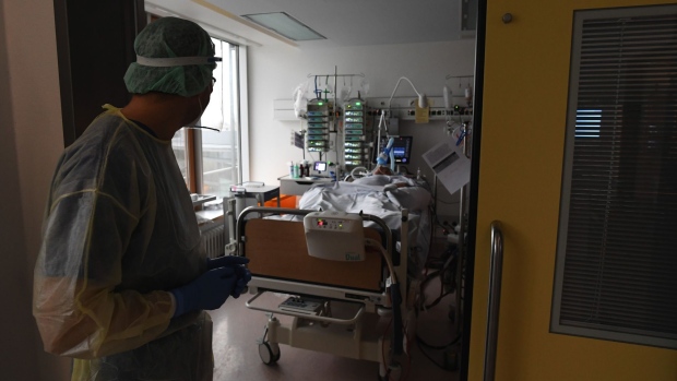 A doctor checks on a Covid-19 patient in the ICU ward at the Robert Bosch Hospital in Stuttgart, Germany, on Tuesday, Jan. 12, 2021. Chancellor Angela Merkel warned that Germany faces hard lockdown measures into late March if authorities fail to contain a fast-spreading variant of the coronavirus. Photographer: Andreas Gebert/Bloomberg