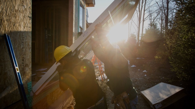 Contractors install a sliding door for a home under construction. Photographer: Michael Nagle/                                