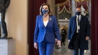 U.S. House Speaker Nancy Pelosi, a Democrat from California, left, wears a protective mask while walking to the House Chamber at the U.S. Capitol in Washington, D.C., U.S., on Tuesday, Jan. 19, 2021. President-elect Joe Biden is set to arrive in Washington on Tuesday, the eve of his inauguration, with the usual backdrop of celebrations and political comity replaced by a military lockdown.