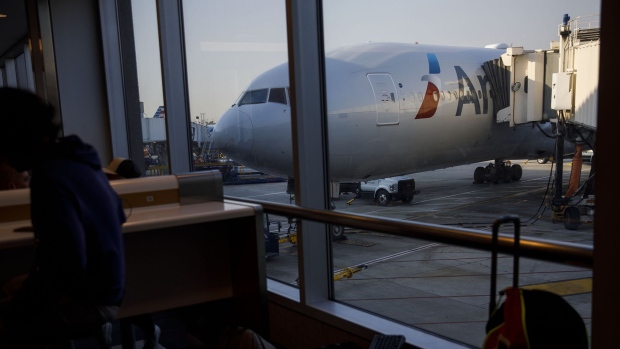 An American Airlines Group Inc. airplane sits at a gate at Los Angeles International Airport.