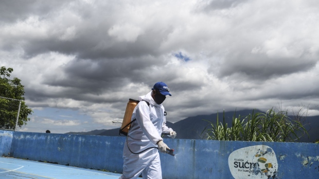 A city crew member disinfects a sports court in the Petare neighborhood of Caracas, Venezuela, on Thursday, Sept. 3, 2020. After a dip in late August, Venezuela is seeing an uptick of daily cases as the country nears 50,000 infections.