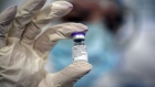 A healthcare worker holds a vial of the Pfizer-BioNTech Covid-19 vaccine at the Mother and Child Hospital in Belgrade, Serbia, on Sunday, Jan. 10, 2021. 
