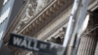 A Wall Street street sign in front of the New York Stock Exchange (NYSE) in New York, U.S., on Monday, Jan. 4, 2021.