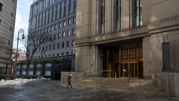 A pedestrian passes in front of the Daniel Patrick Moynihan U.S. District Court for the Southern District of New York Courthouse in New York, U.S., on Monday, Dec. 21, 2020. With vaccinations heralding a return to normalcy, the next year should see courtrooms around the world coming back to life. Ghislaine Maxwell, China critic Jimmy Lai and Samsung heir Jay Y. Lee are among those facing high-profile criminal cases in 2021. Photographer: Michael Nagle/Bloomberg